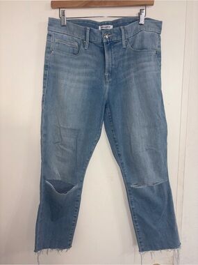 Good American light wash jeans feature ripped knees raw, distressed hem 10